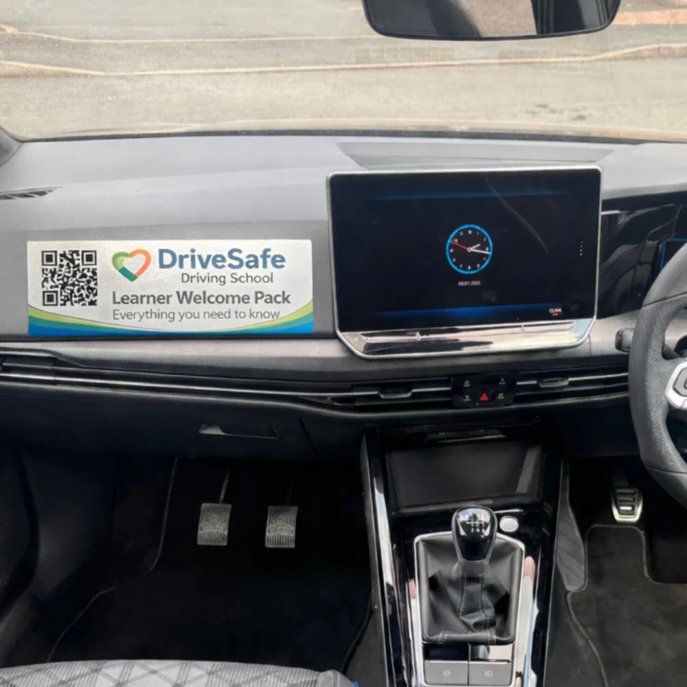 learner car with welcome sticker on dashboard